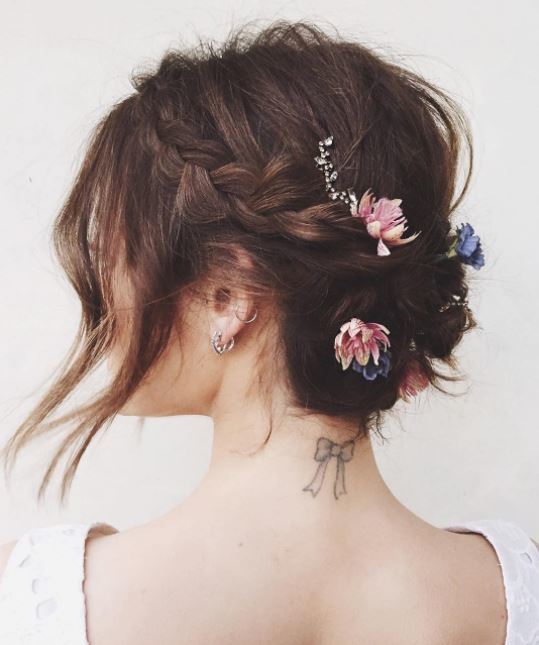 Short hair wedding updos - brunette hair with braids and flowers places throughout. Loose front section framing face
