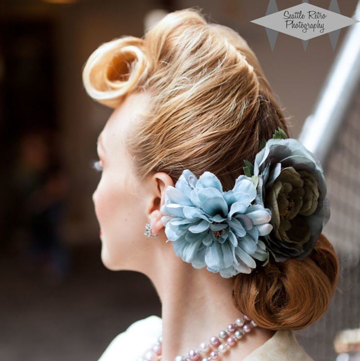 Vintage wedding hairstyles - blond hair with victory roll at the front and blue flowers at the back in a updo