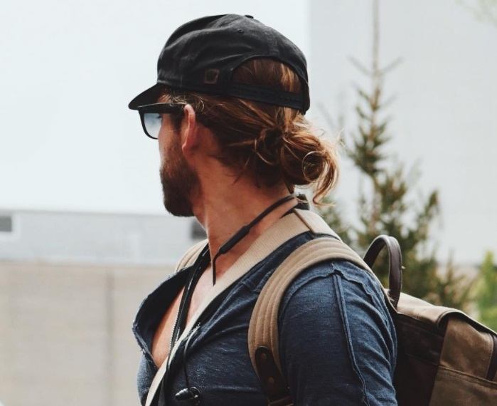 back shot of man with low male top knot hairstyle