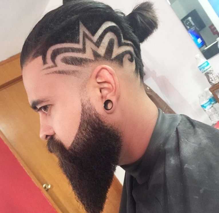 modern top knot men hairstyle featuring shaved hair design