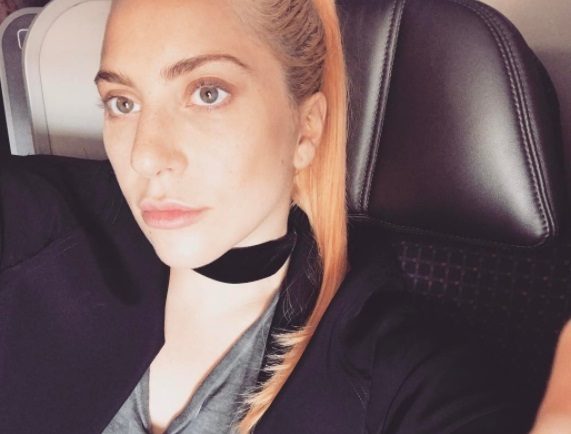 lady gaga with peach hair styled into a ponytail