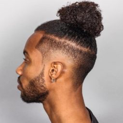 black men with textured male top knot hairstyle with disconnected fade