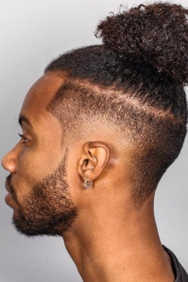 black men with textured male top knot hairstyle with disconnected fade