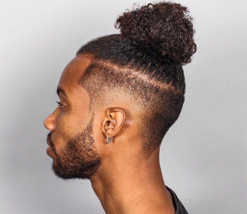 black men with textured male top knot hairstyle with disconnected fade
