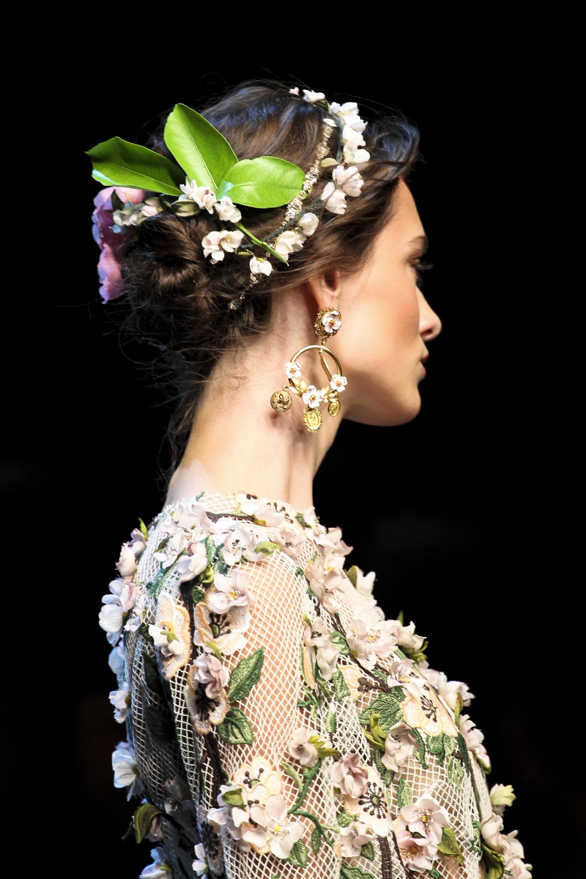 runway shot of model with low flower updo hairstyle wearing floral outfit dolce and gabanna