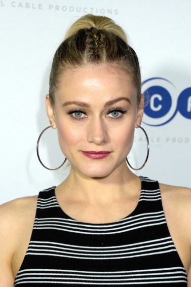 the magicians actress olivia taylor dudley with her blonde hair in a parting plait