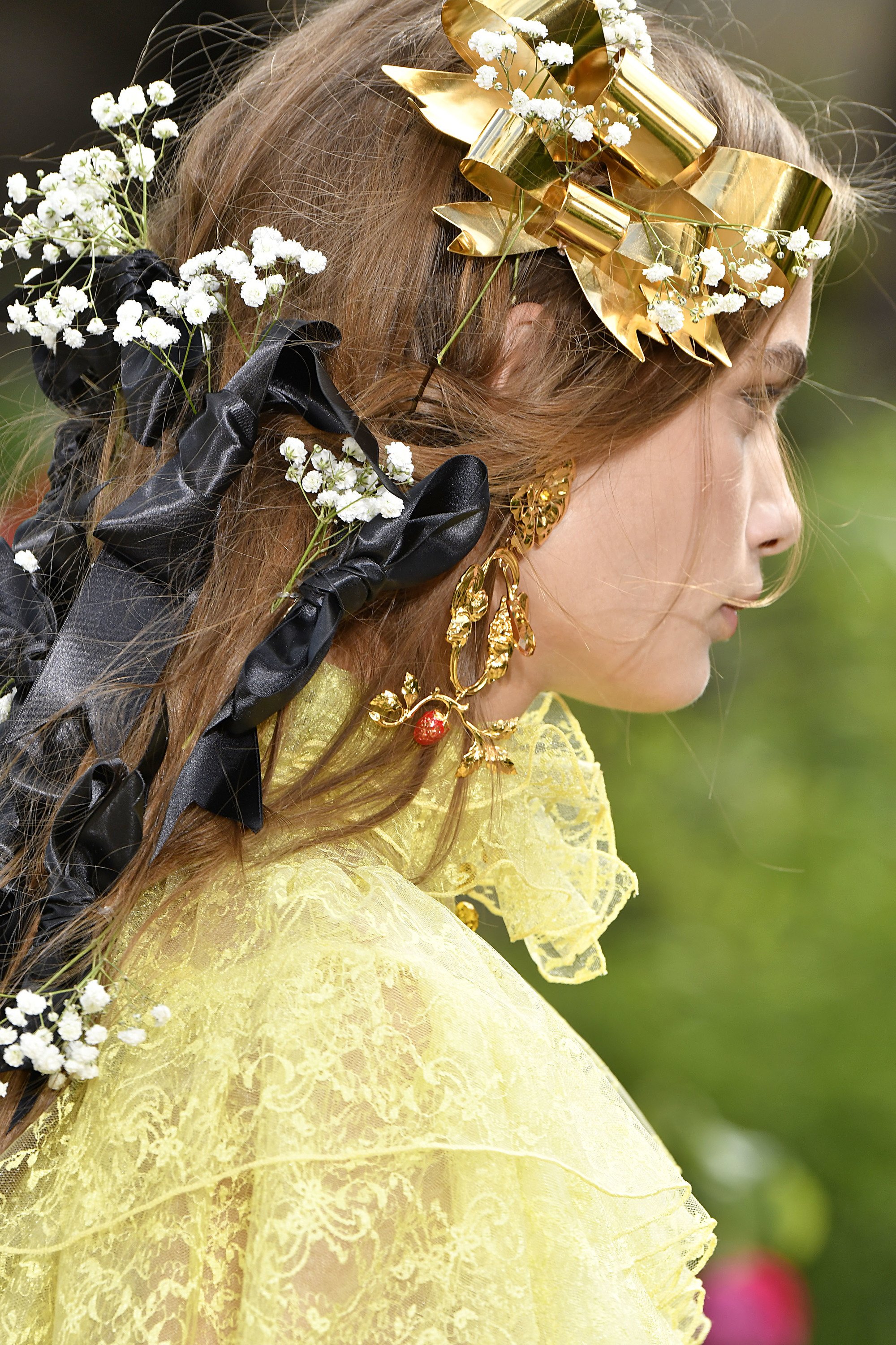 model with flowers and bows in her hair on the rodarte runway