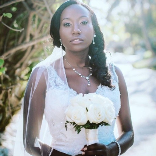 woman with her hair in a side braid with a wedding veil