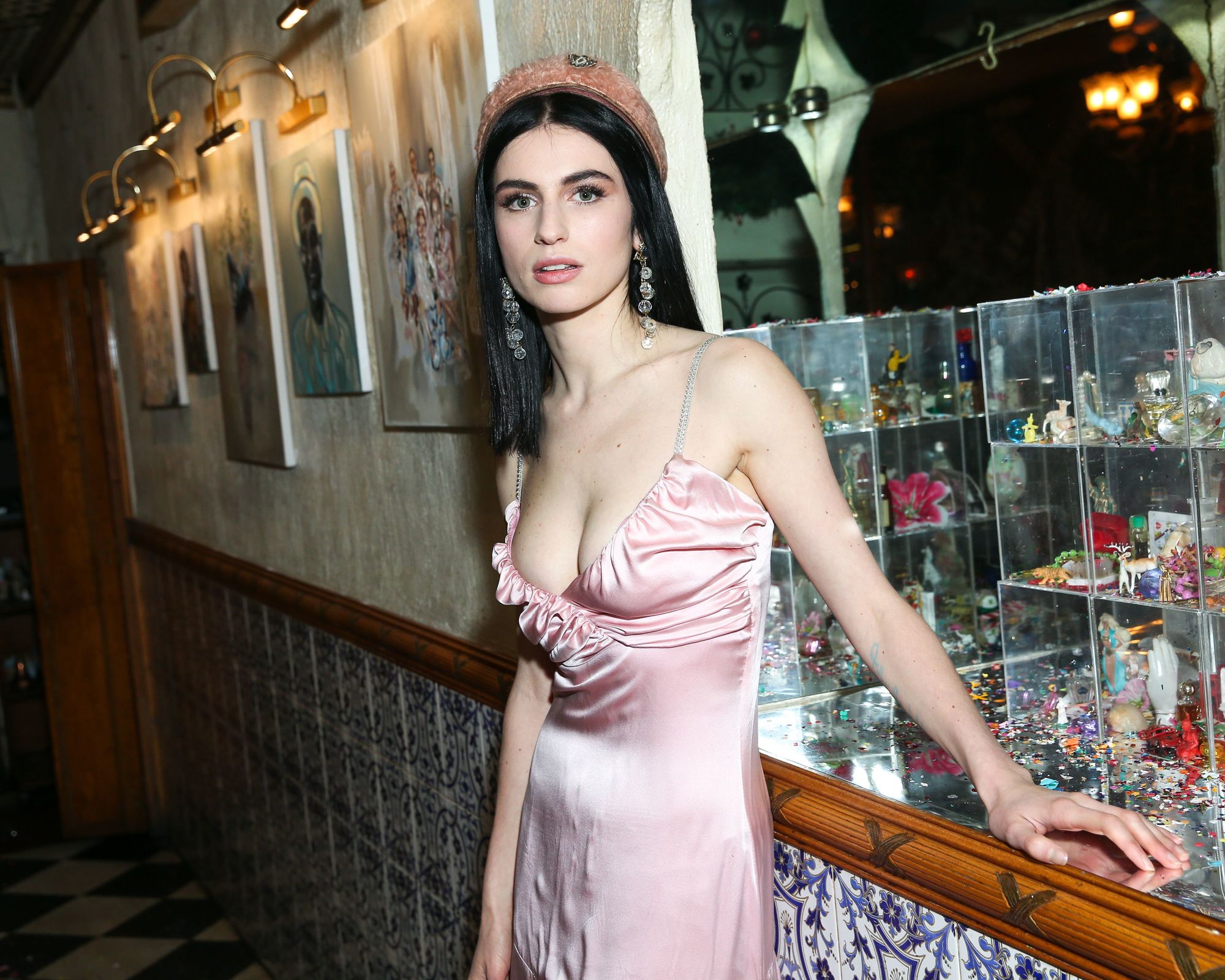 shot of tali lennox with pink satin dress and pink beret at an event