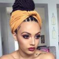 woman with box braids hairstyle styled into a bun updo with a scarf around it