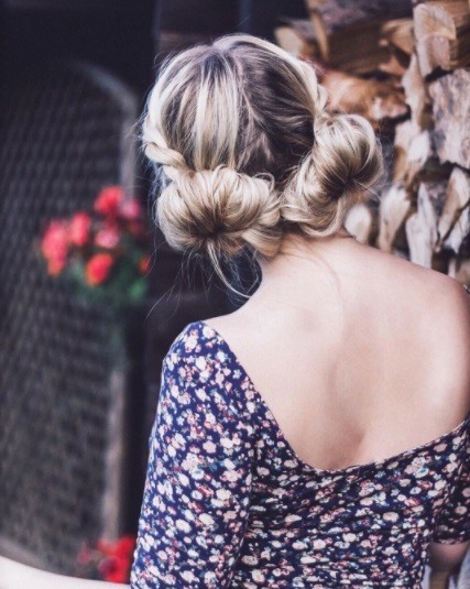 back view of a woman wearing a floral dress with her hair in big macaron bunsZDW