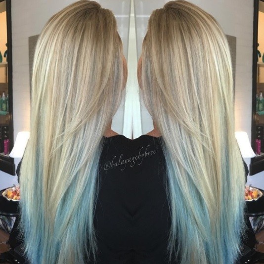 back view of a woman with long straight blonde hair with blue ombre