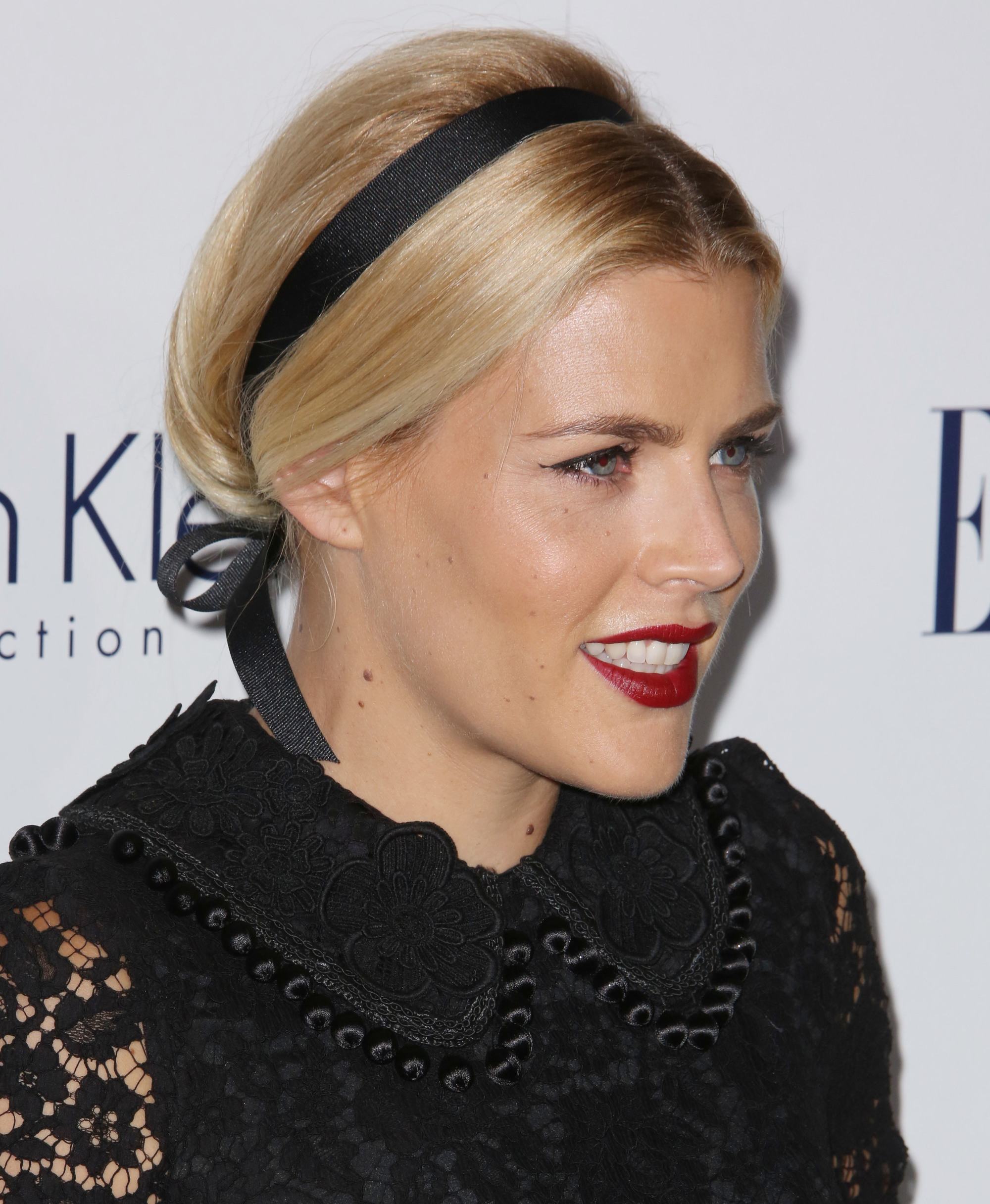 short hairstyles for school: shot of busy phillips with short updo hairstyle with ribbon hair accessory