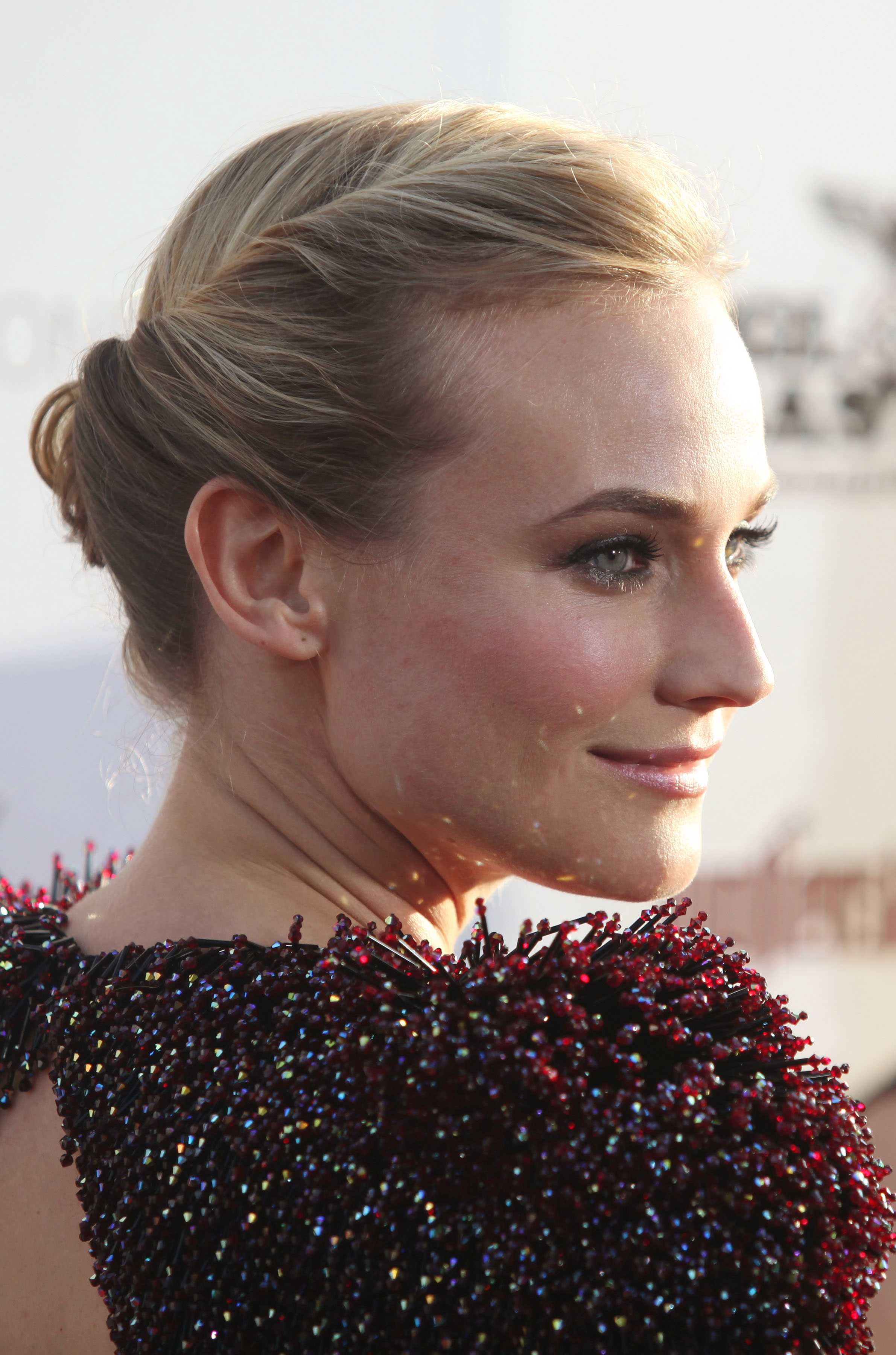 prom hairstyles for medium hair: diane kruger blonde straight hair styled in a twisted updo