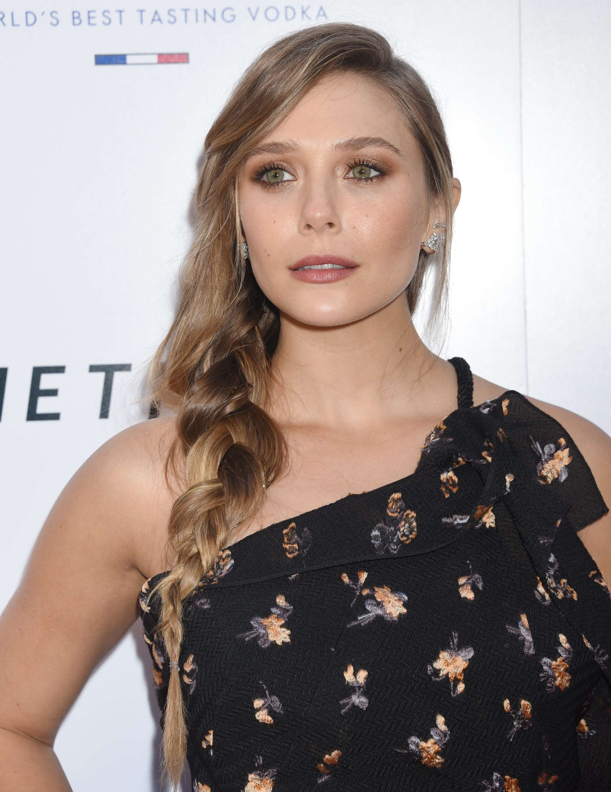 Elizabeth Olsen bronde coloured hair in loose side plait braid hairstyle at premiere