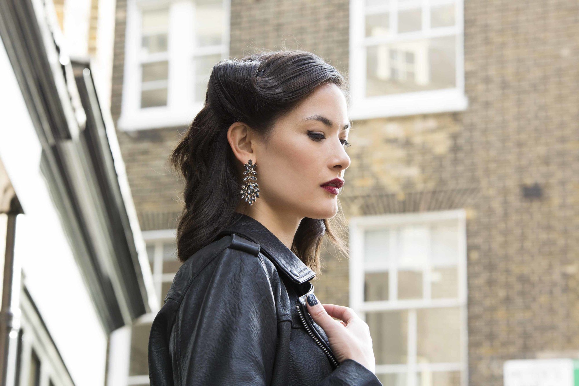 Dark haired model wearing her medium length hair in glam waves vintage style