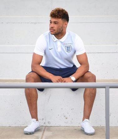 Alex Oxlade Chamberlain with brown faded hairstyle with golden brown tips wearing England football shirt
