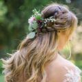 Blonde long wavy hair with double braids half-up. half-down hairstyle with floral detailing