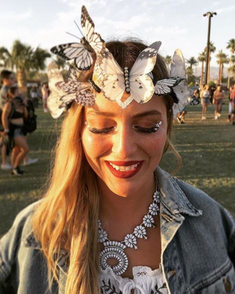 girl with medium long straight hair wearing a white butterfly headband crown at Coachella 2017 festival.