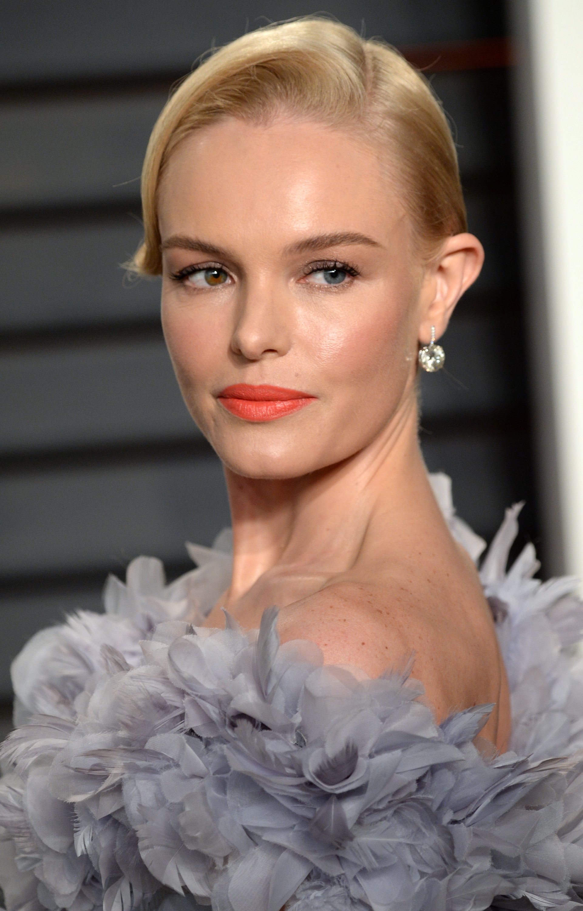 prom hairstyles for medium hair: kate bosworth light blonde straight hair styled in a side parted bun updo