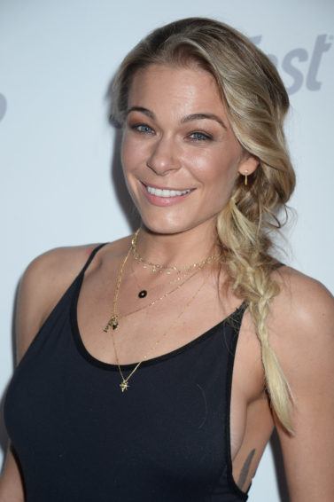 country singer leann rimes with her long blonde hair in a side braid