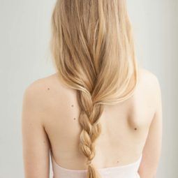 Blonde woman with long loose messy braid