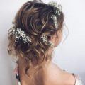 Light brown balayage hair with wavy pinned up finish and baby's breath flowers