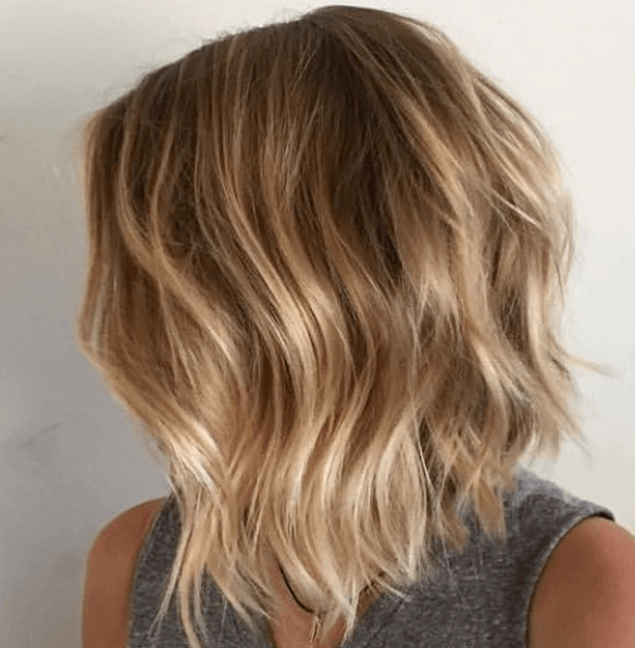 long bob graduated bob haircut with brown to blonde balayage hair with wavy finish
