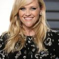 actress reese witherspoon with blonde side bangs and curly hair