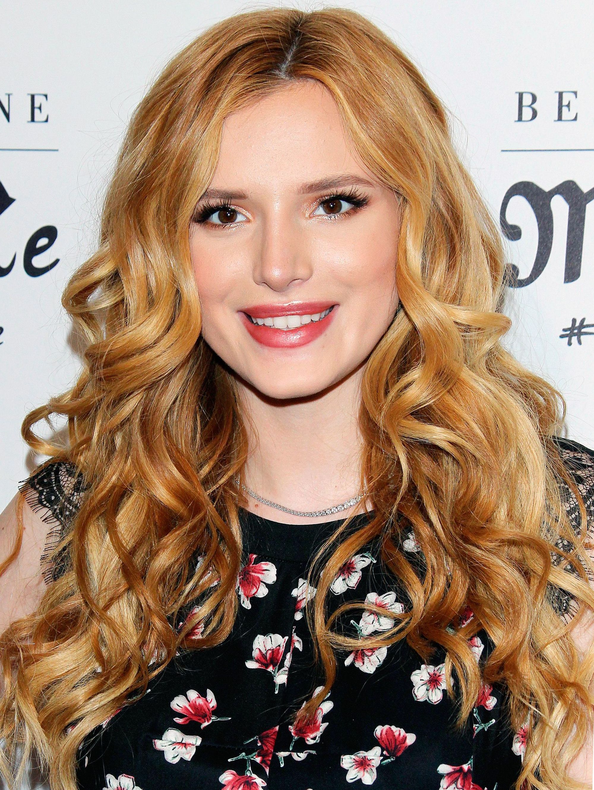 Bella Throne long strawberry blonde hair with highlights and wavy finish