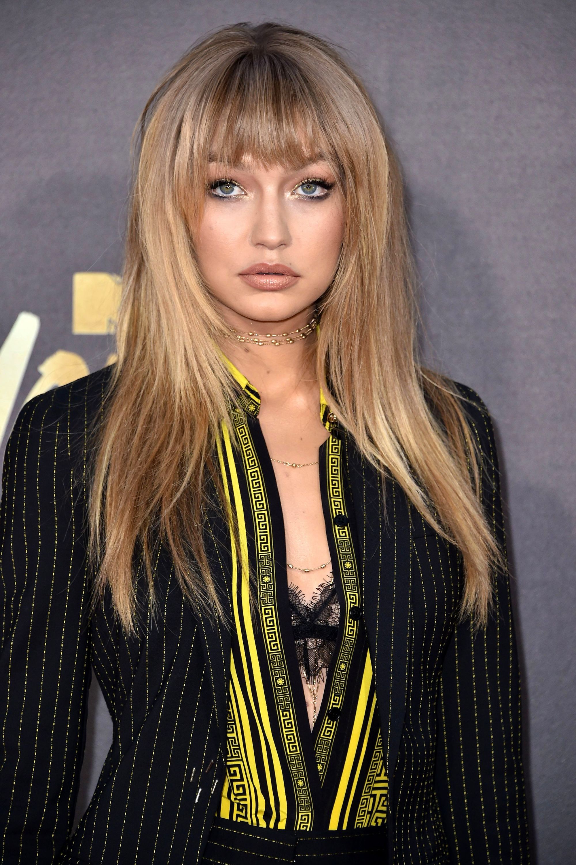 Gigi Hadid with long straight hair and full bangs fringe
