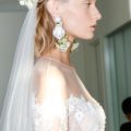 simple wedding hairstyles: side shot of model with half up half hairstyle on the bridal runway at marchesa