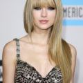 singer taylor swift with long straight blonde hair and bangs
