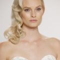 simple wedding hairstyles: shot of model with side swept curls on the runway