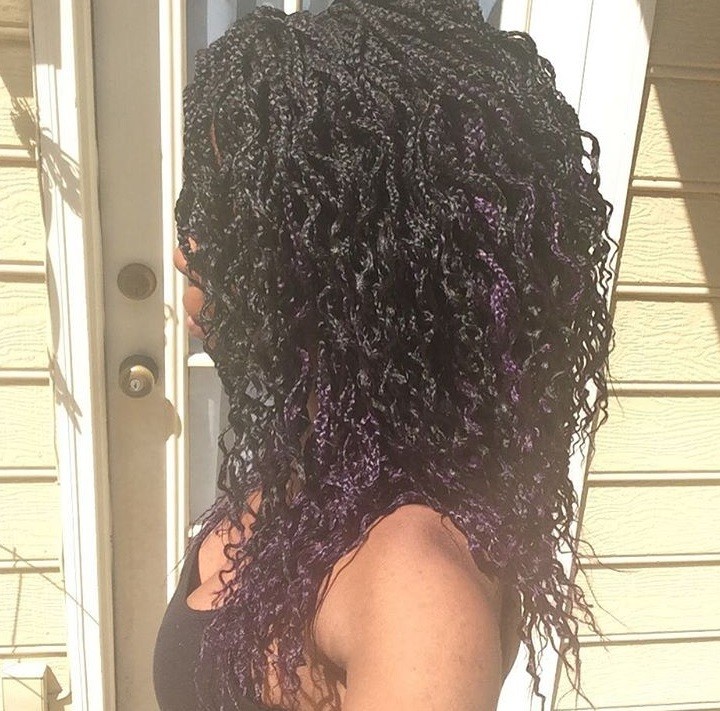 outdoor shot of woman with curly braids wearing black top