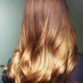 back view of a woman with auburn to blonde ombre hair