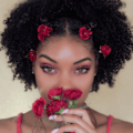 close up shot of woman with bantu knot with flowers in them
