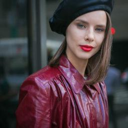 close up shot of woman with beret hairstyle, wearing red leather