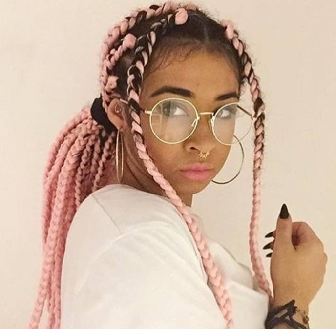 box braids ponytail: woman with pink box braids hairstyle styled into a ponytail