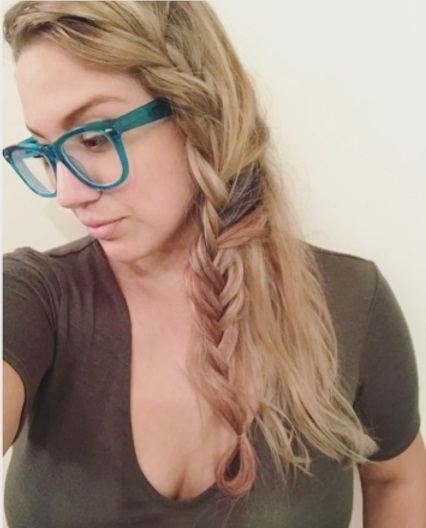 blonde woman taking a selfie with her hair in a half boho braid