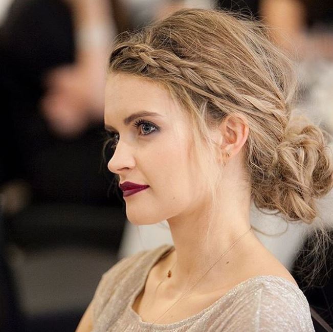 side view of dirty blonde hair with low messy bun and braid