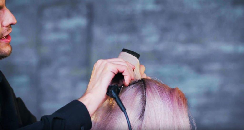 Superdrug Loves cartoon kid Halloween hair tutorial side view of hair being curled with straightener