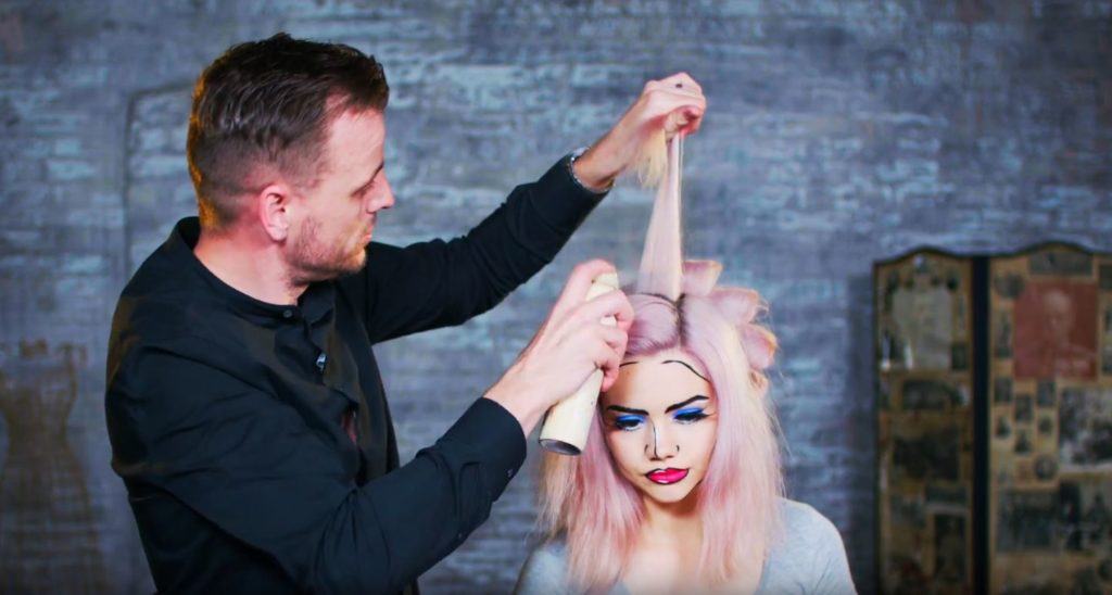 Superdrug Loves cartoon kid Halloween hair tutorial front view of hair being sprayed with hairspray