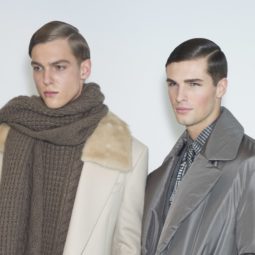 shot of male models with a classic side slick hair style on the runway wearing smart clothing