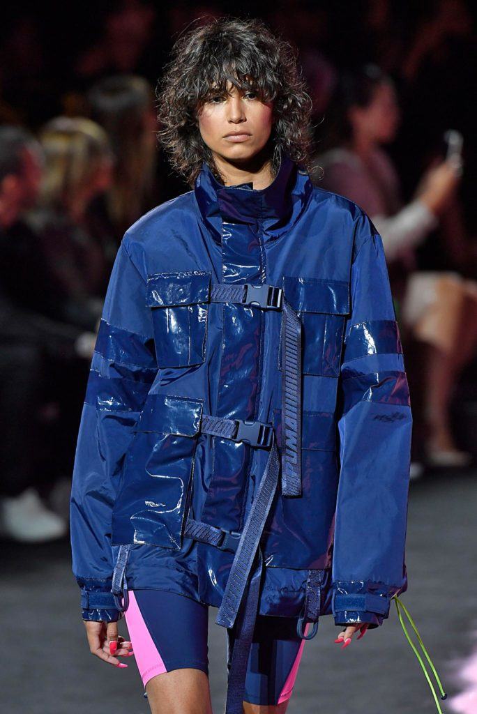 model on NYFW runway with dark brown curly shag haircut