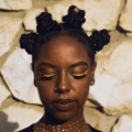 close up shot of woman with braided bantu knots on weave