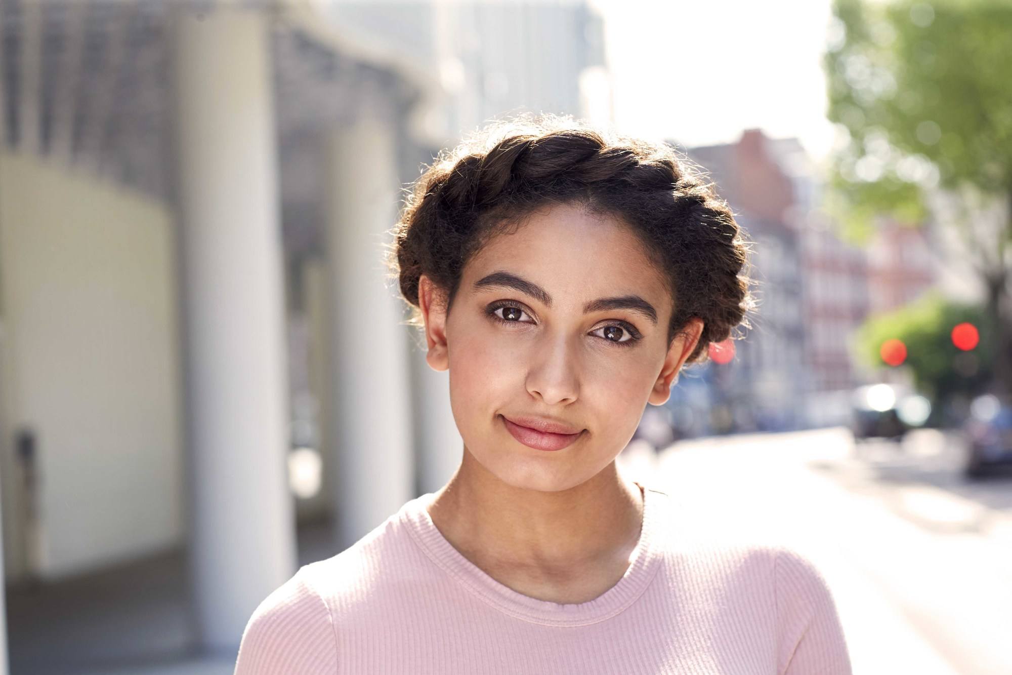 streetstyle shot of a woman with dark afro hair in a flat twist halo braid style