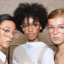 Anti-frizz spray: Models backstage with straight and natural curly hair in different lengths and colours all wearing glasses.