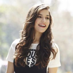 Brunette model laughing outside with heatless curls: