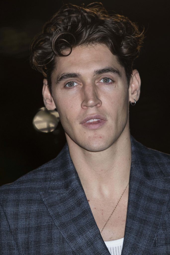 close up shot of isaac carew with curly quiff hairstyle and checked suit on the GQ Men of the Year Awards